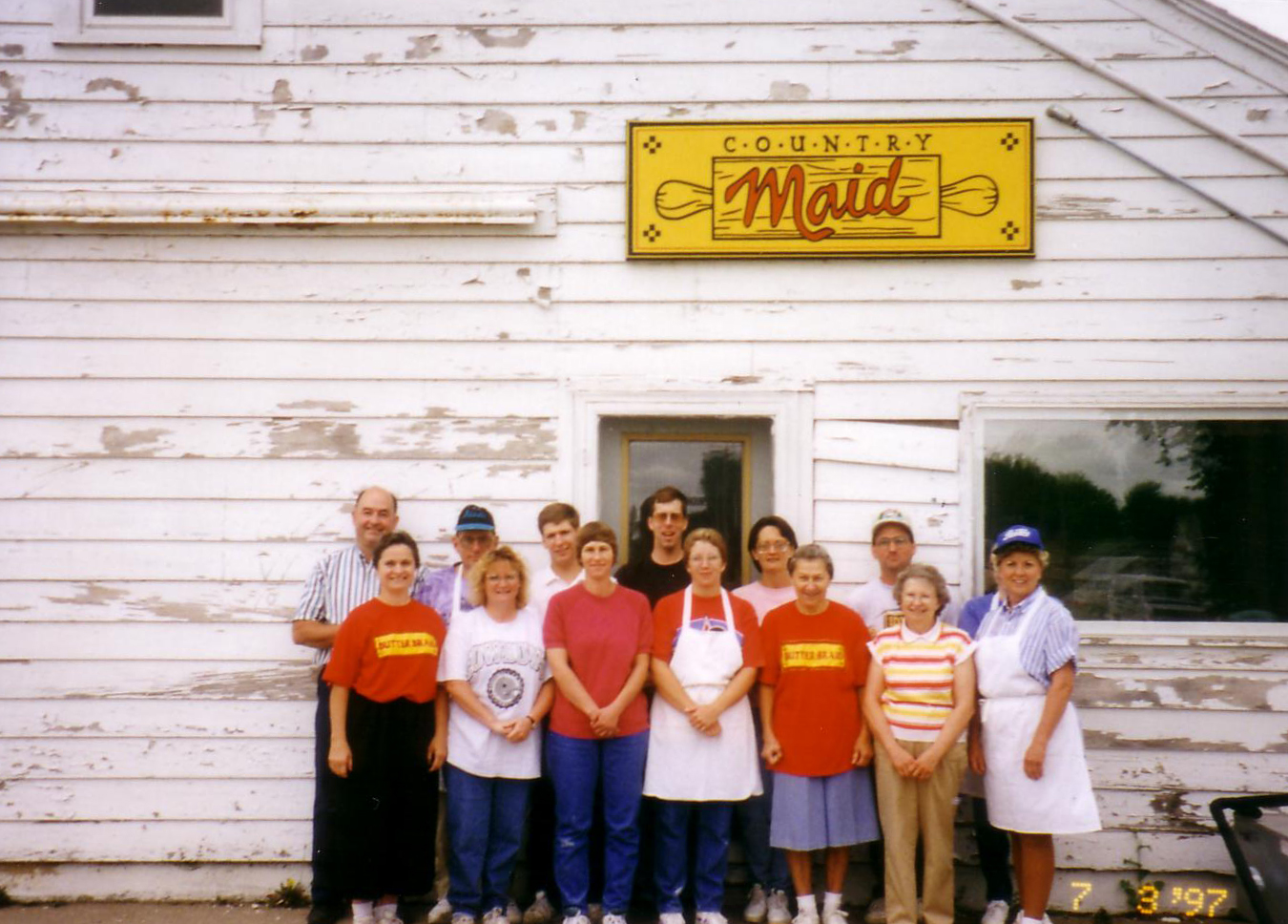 Group of Country Maid employees in front of old office - Hatchery