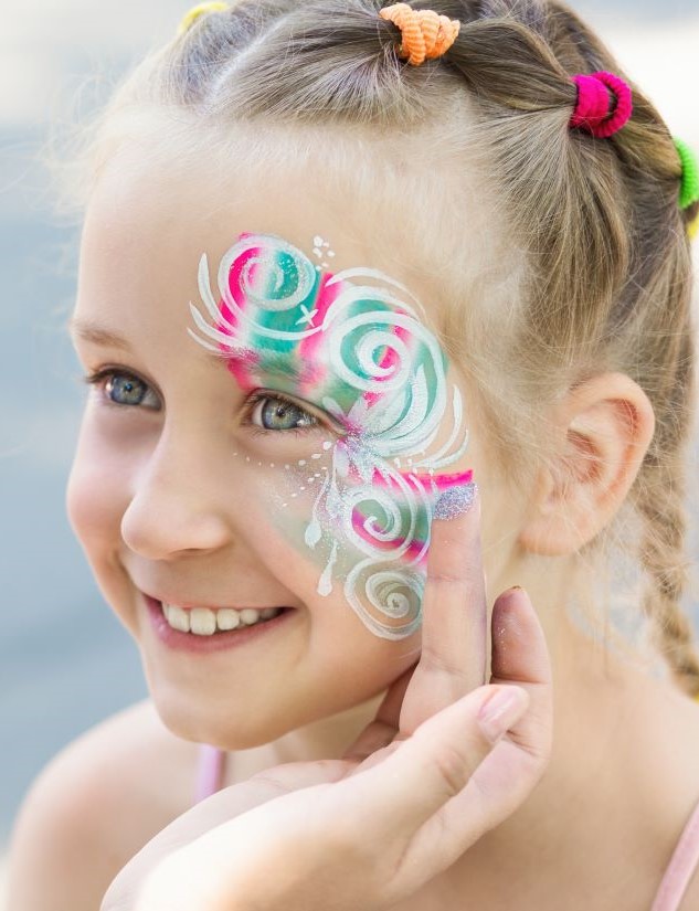 Little girl getting her face painted