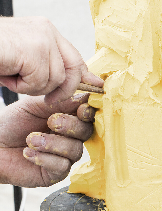 Better Butter Bash Butter Carving Contest - persons hands carving a 50 lb. block of butter